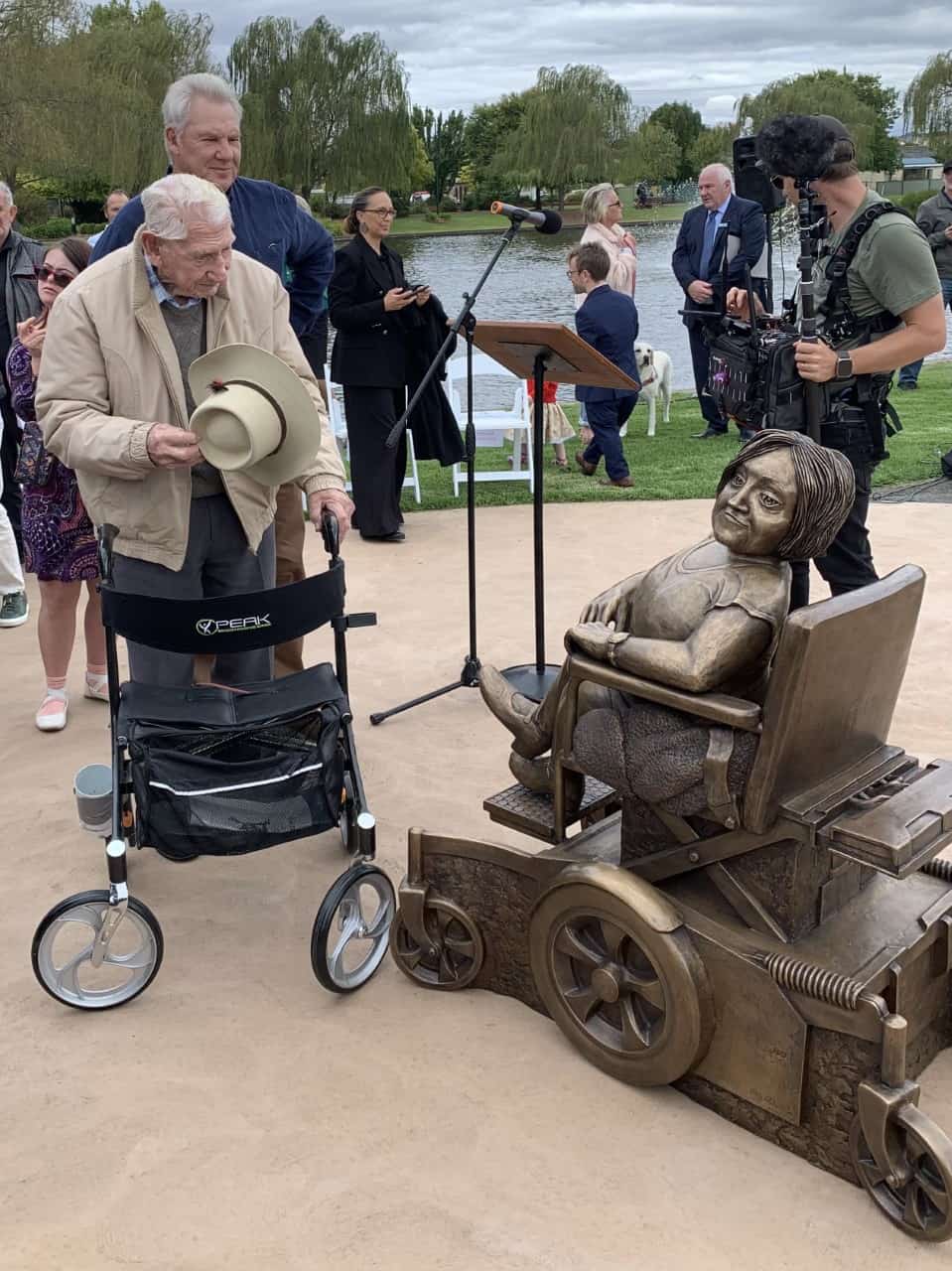 Two gentlemen pay their respects to Stella Young's statue